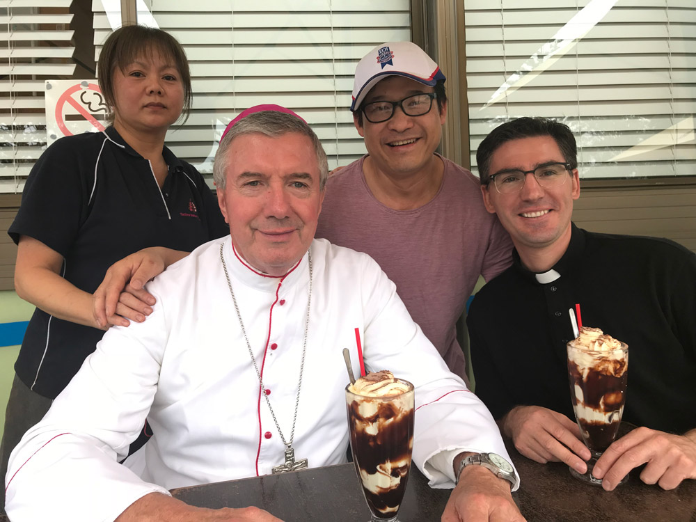 Archbishop Christopher Prowse and Fr Luke Verrell with Quyen and Joe Nguyen at the bakery. Picture: Supplied.