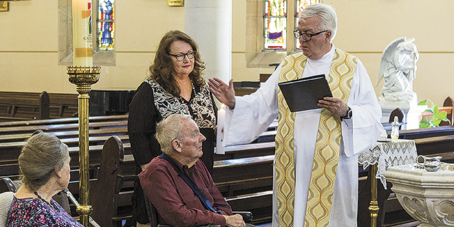 Sacred moment: Fr Peter Dillon blessed Bill Hayden at St Mary’s Church, Ipswich. Photos: Alan Edgecomb