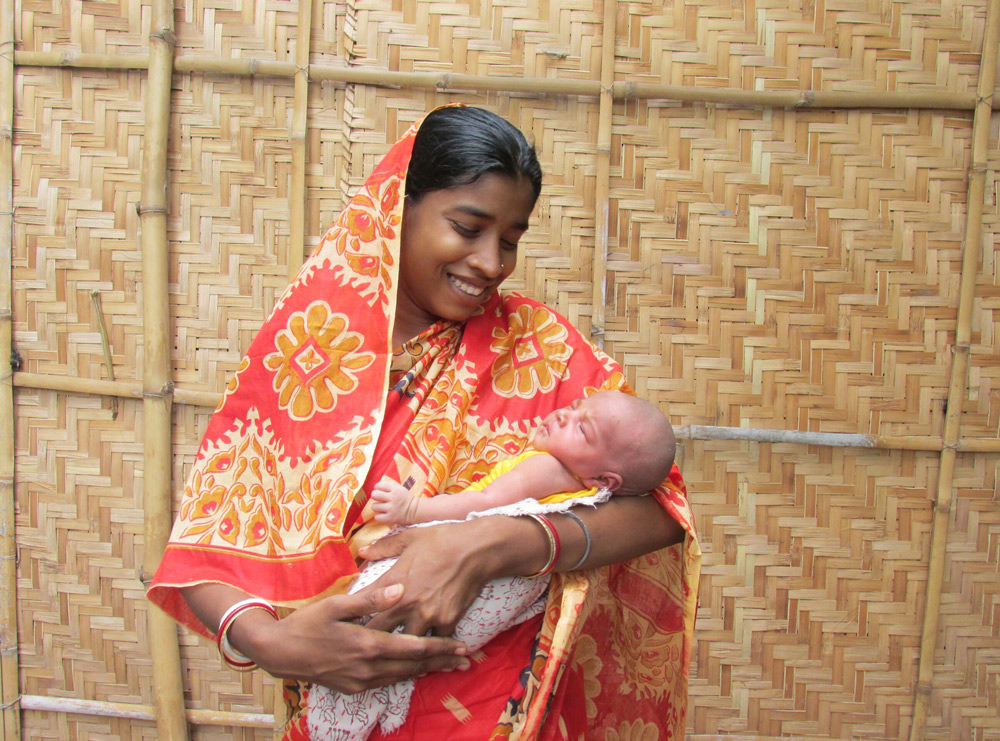 Lima, who was assisted during her birth by Caritas trained midwife Monika, cradles her healthy baby Jyoti. Photo: CARITAS.